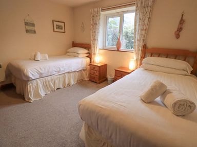 A bedroom with two beds and a window at Thrang View in Chapel Stile