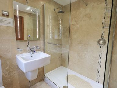 A bathroom with a shower and sink at Thrang View in Chapel Stile