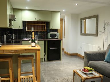 A kitchen with a countertop and modern appliances at Rockfish Cottage in Brixham