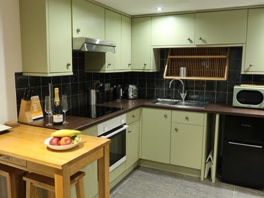 A kitchen with a countertop, sink, and stove at Rockfish Cottage in Brixham