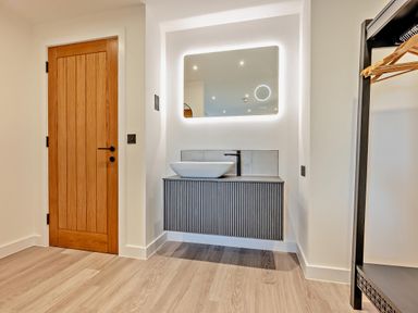 A bathroom with a sink and mirror at Arvor Suite 1.0 in Marhamchurch