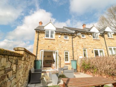 An outdoor area with patio furniture at Ramblers Cottage in Alnwick