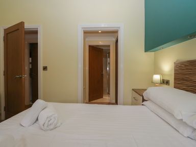 A bedroom with a bed and doors at High Lake View Lodge near White Cross Bay