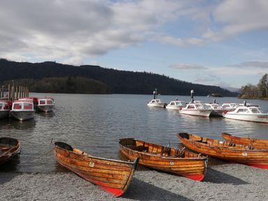 A lakeside scene with boats and a pier at High Lake View Lodge White Cross Bay near Troutbeck Bridge