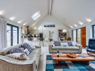 A living room with a sofa and coffee table at Beachcombers in Marhamchurch