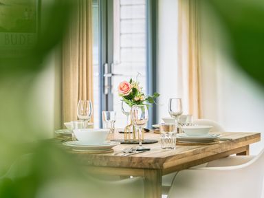 A dining room table set with tableware at Little Main in Marhamchurch