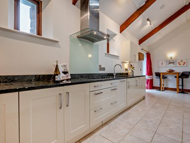 A kitchen with cabinets and sink at Middle Hill in Marhamchurch