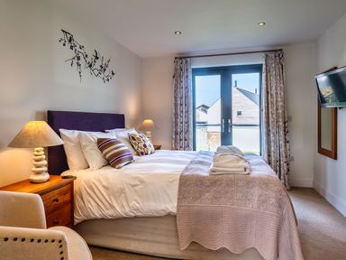 A bedroom with a bed and window at Venners in Marhamchurch