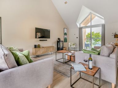 A living room with a sofa and coffee table at Gwari Spa Barn 2.0 Marhamchurch