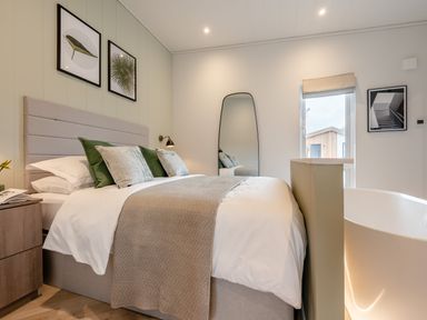 A bedroom with a bed and a bathtub at Trelowen 2.0 Spa in Marhamchurch
