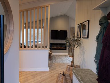 A living room with a television and fireplace at Trelowen 2.0 Spa in Marhamchurch