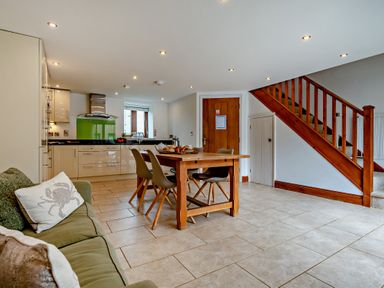 A kitchen with a dining table and chairs at Jack's House in Marhamchurch