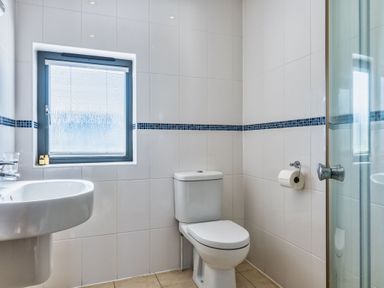 A bathroom with a sink and toilet at Arundell in Marhamchurch