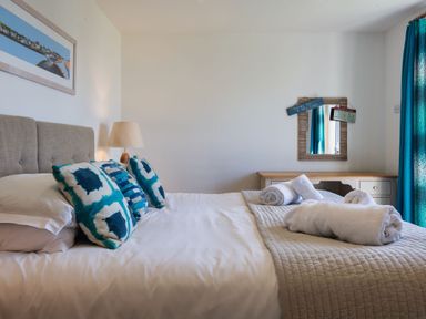 A bedroom with a bed and desk at Eagle's Nest in Marhamchurch