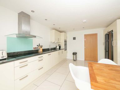 A kitchen with modern appliances and countertops at Medlands in Marhamchurch