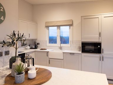A kitchen with cabinets and a sink at Trelowen 3.0 Spa in Marhamchurch