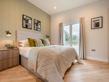 A bedroom with a bed and window at Trelowen 3.0 Spa in Marhamchurch