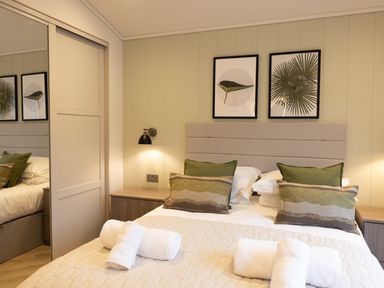 A bedroom with a bed and pillows at Trelowen 3.0 Spa in Marhamchurch