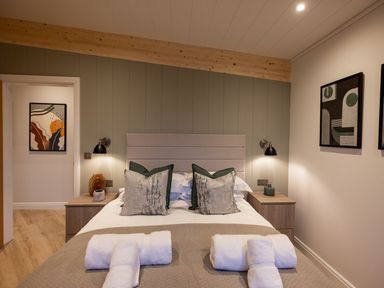 A bedroom with a bed and artwork at Trelowen 3.0 Spa in Marhamchurch