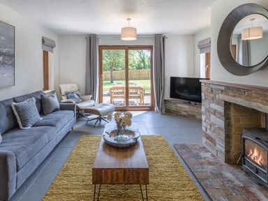 A living room with a sofa and coffee table at Windy Hills Spa in Marhamchurch