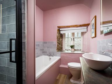 A bathroom with a bathtub, toilet, and sink at Whalesborough Farmhouse Spa in Marhamchurch