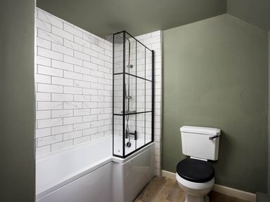 A bathroom with a bathtub and shower at Whalesborough Farmhouse Spa in Marhamchurch