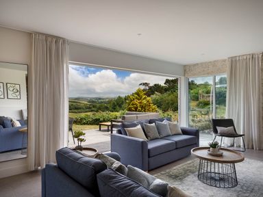 A living room with a sofa and coffee table at Whalesborough Cottage Spa, Marhamchurch