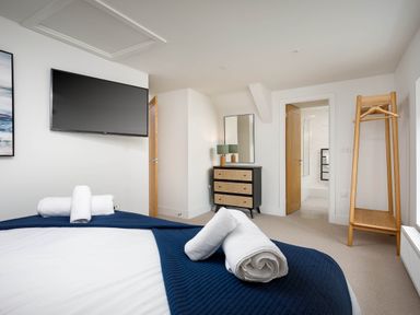 A bedroom with towels on a bed at Whalesborough Cottage Spa Marhamchurch