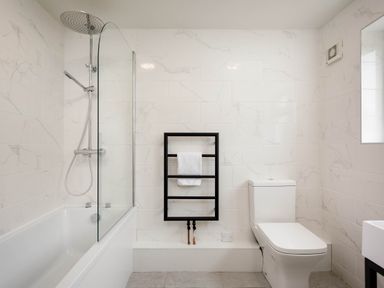 A bathroom with a shower and bathtub at Whalesborough Cottage Spa in Marhamchurch