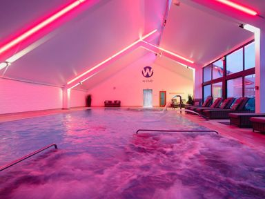 A pool area with lounge chairs at Calf House Spa in Marhamchurch