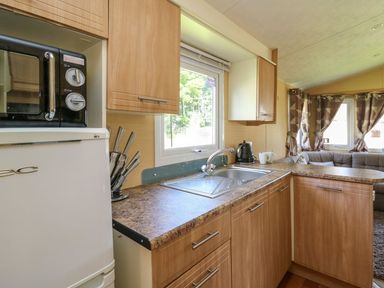 A kitchen with a sink and appliances at Caravan 2 at Blackmoor Farm near tenby