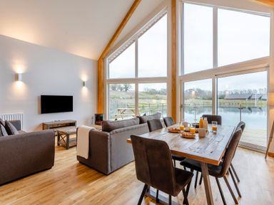 A living room with a view of a lake at Tranquillity 4 in Carnforth