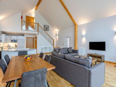 A living room with a sofa and dining table at Tranquillity 4 in Carnforth
