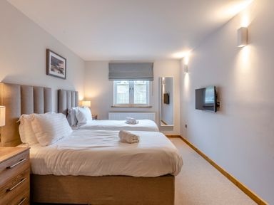 A bedroom with two beds and a television at Tranquillity 4 in Carnforth