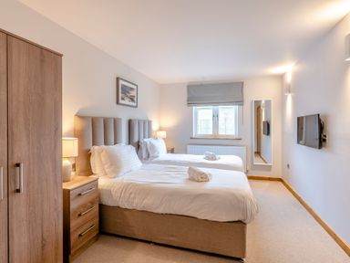 A bedroom with two beds and a television at Tranquillity 4 in Carnforth