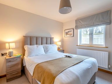 A bedroom with a bed and nightstand at Tranquillity 4 in Carnforth