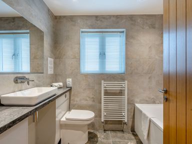 A bathroom with a sink and a bathtub at Tranquillity 4 in Carnforth