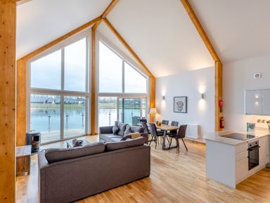 A living room with a seating area and kitchen at Tranquillity 4 Carnforth