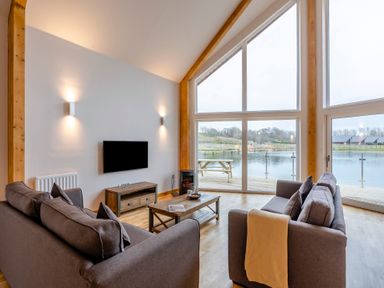 A living room with a view of water at Tranquillity 4 (Pet) in Carnforth