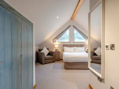 A bedroom with a bed and seating area at Tranquillity 4 (Pet) Carnforth