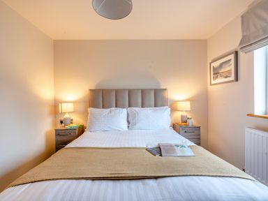 A bedroom with a bed and nightstands at Tranquillity 4 (Pet) in Carnforth