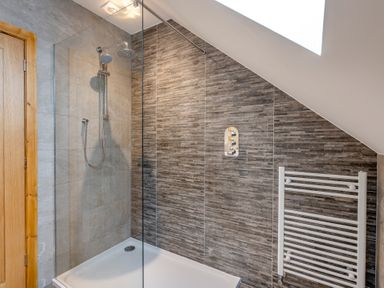 A bathroom with a shower and towel radiator at Tranquillity 4 (Pet) in Carnforth