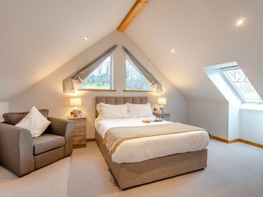 A bedroom with a bed and a chair at Tranquillity 4 (Pet) Carnforth