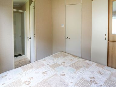 A bedroom with a bed and a shower at Caravan 3 at Blackmoor Farm near tenby Narberth