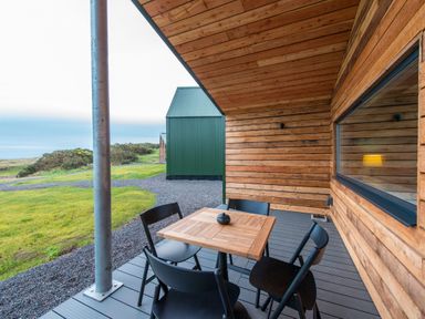 A wooden table with black chairs on a patio at The Telfer in North Berwick