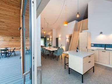 A kitchen with a table and seating at The Telfer in North Berwick