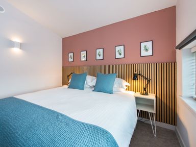A bedroom with a bed and wall art at The Telfer in North Berwick