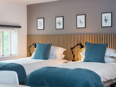 A bedroom with two beds and wall art at The Telfer in North Berwick