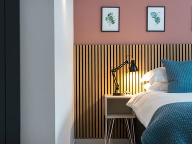 A bedroom with a bed and lamp at The Telfer in North Berwick