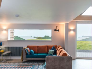 A living room with a sofa and a table at The Irvine in North Berwick